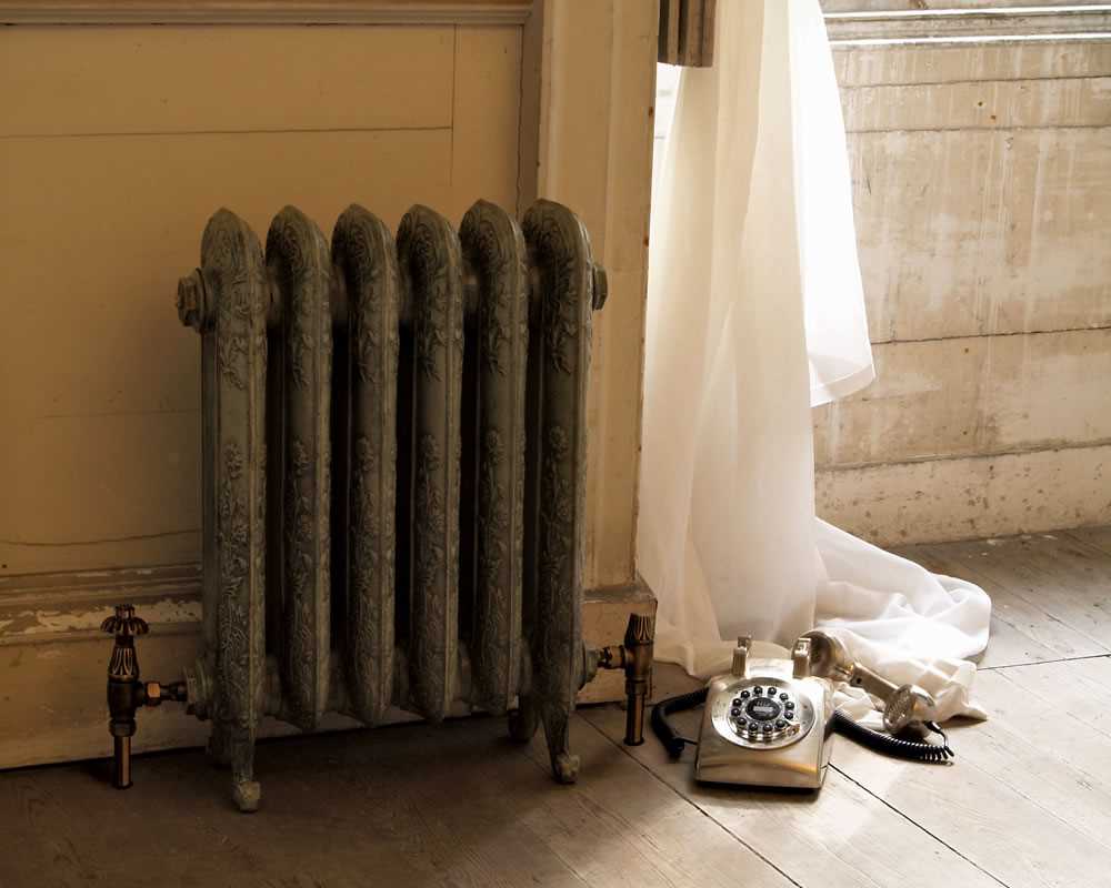 cast iron radiator in antiqued french grey finish in period property