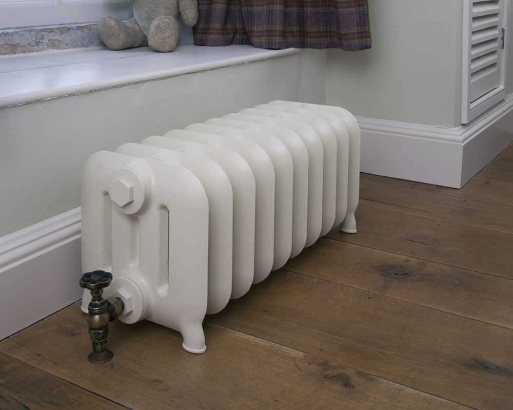 Duchess 4 column cast iron window radiator painted in buttermilk with brass Daisy wheel valve